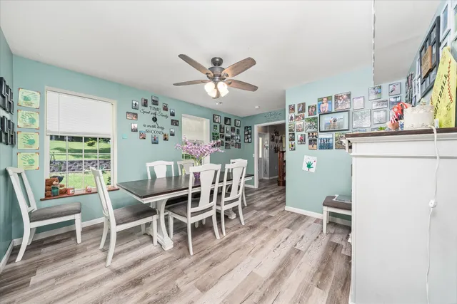 a dining room with furniture and a large window
