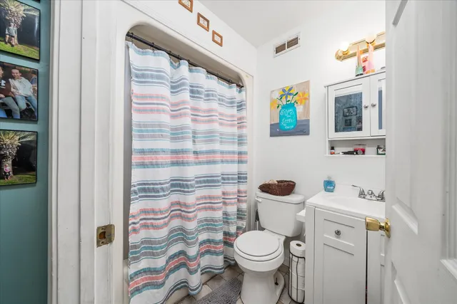 a white toilet sitting next to a bathroom sink