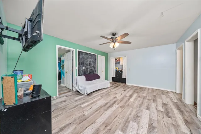 a bedroom with a bed and a chandelier