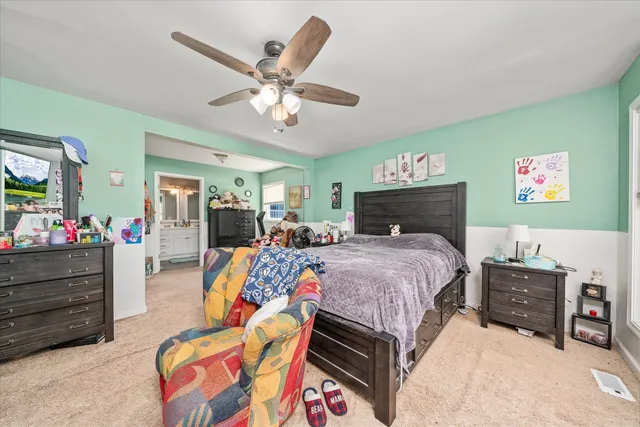 a bed room with a bed mirror and a window