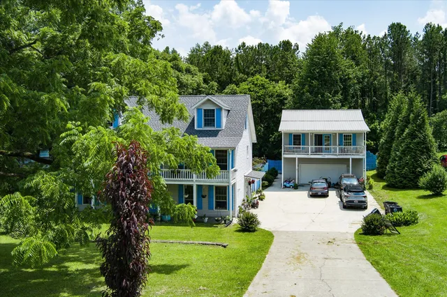a view of house with yard and green space