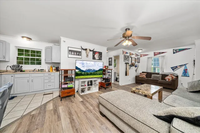 a kitchen with a refrigerator and white cabinets