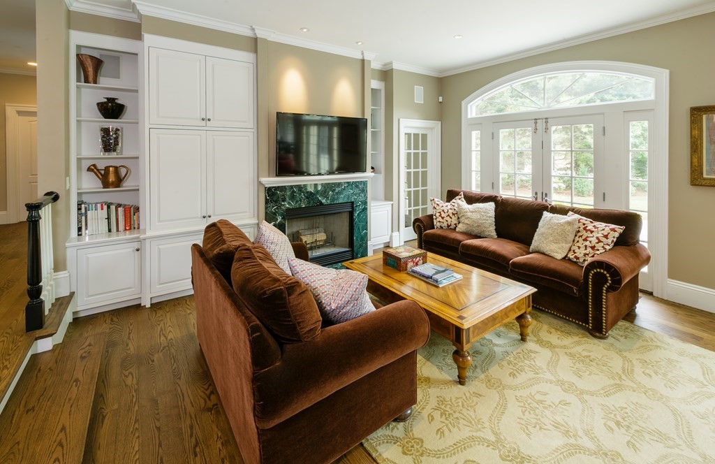 79 Oxbow Road Concord, MA 01742 - Photo 15 of 36 a living room with furniture fireplace and a flat screen tv