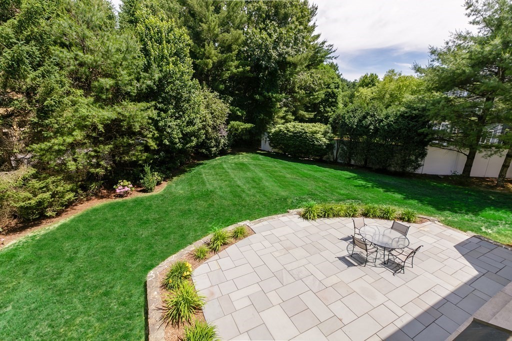 79 Oxbow Road Concord, MA 01742 - Photo 34 of 36 a view of a backyard with a garden and seating area