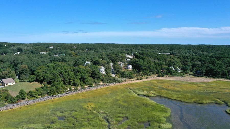 125 Pine Point Road Wellfleet, MA 02667 - Photo 11 of 49 a view of a field with an ocean