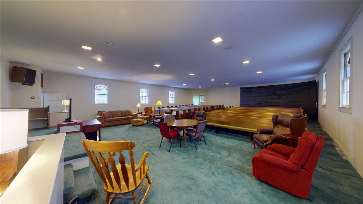 415 Church Street Pendleton, SC 29670 - Photo 8 of 35 A spacious room offers ample gathering space, bathed in natural light from multiple windows.