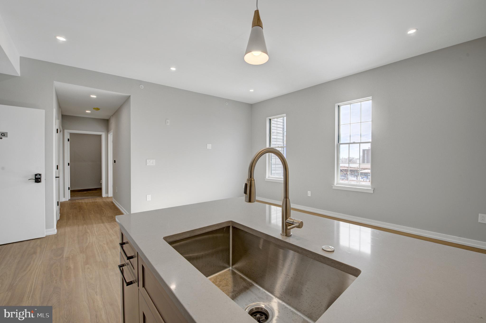 2445 Innovator Way, Unit 4G Philadelphia, PA 19146 - Photo 2 of 32 a kitchen with a sink and chandelier