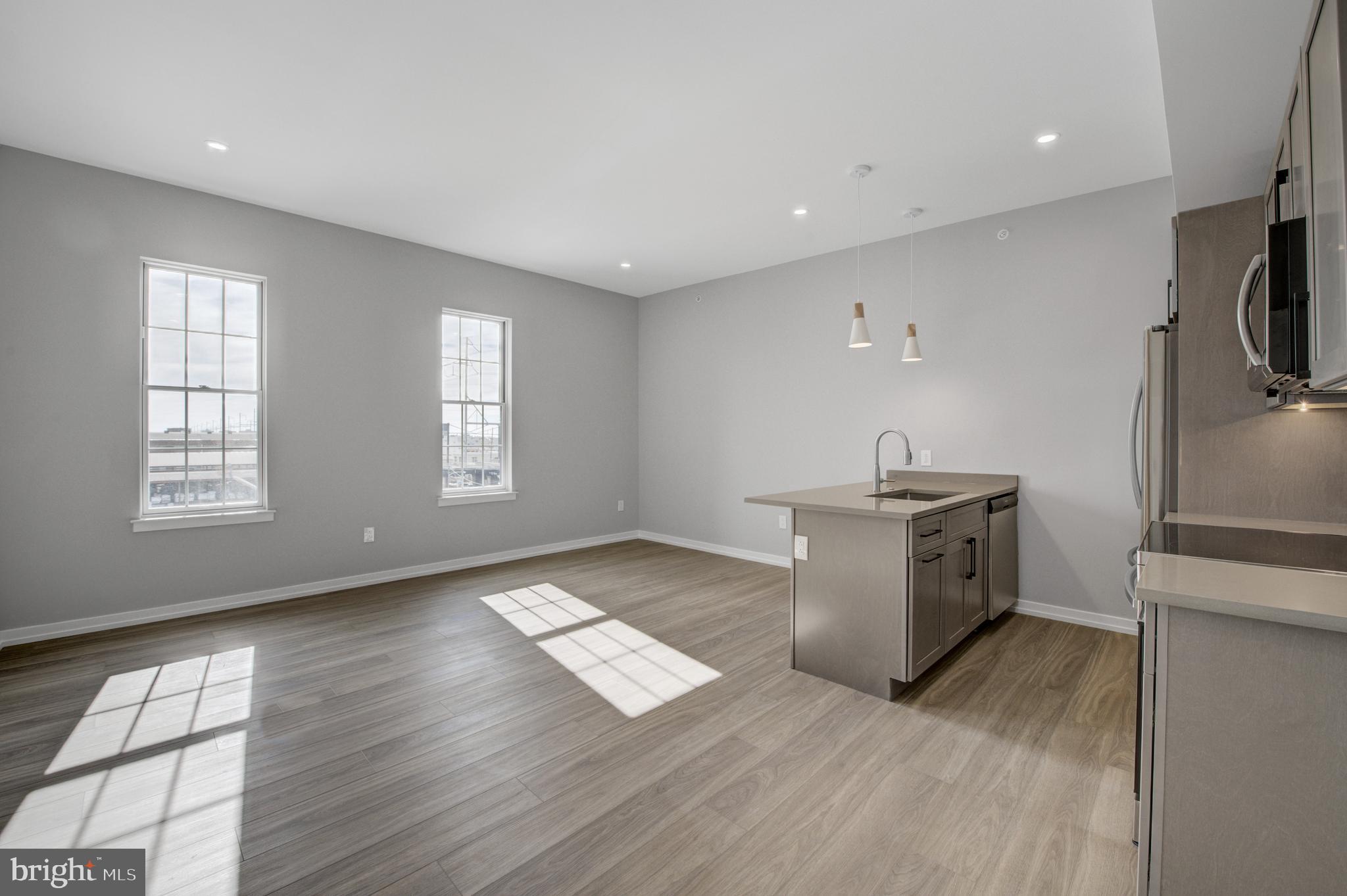 2445 Innovator Way, Unit 4G Philadelphia, PA 19146 - Photo 3 of 32 a kitchen with granite countertop a stove and a refrigerator
