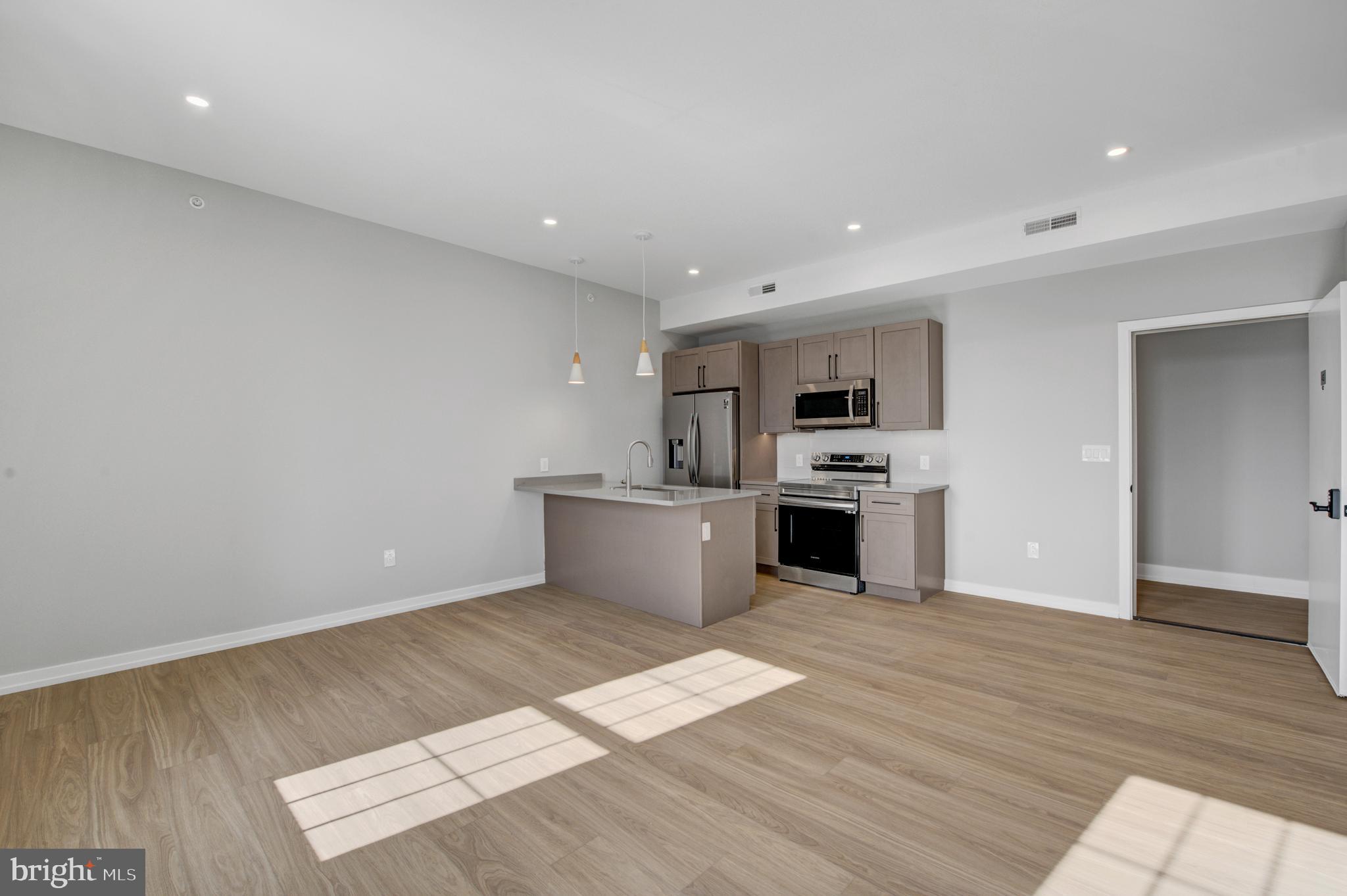 2445 Innovator Way, Unit 4G Philadelphia, PA 19146 - Photo 5 of 32 a view of kitchen with wooden floor and electronic appliances