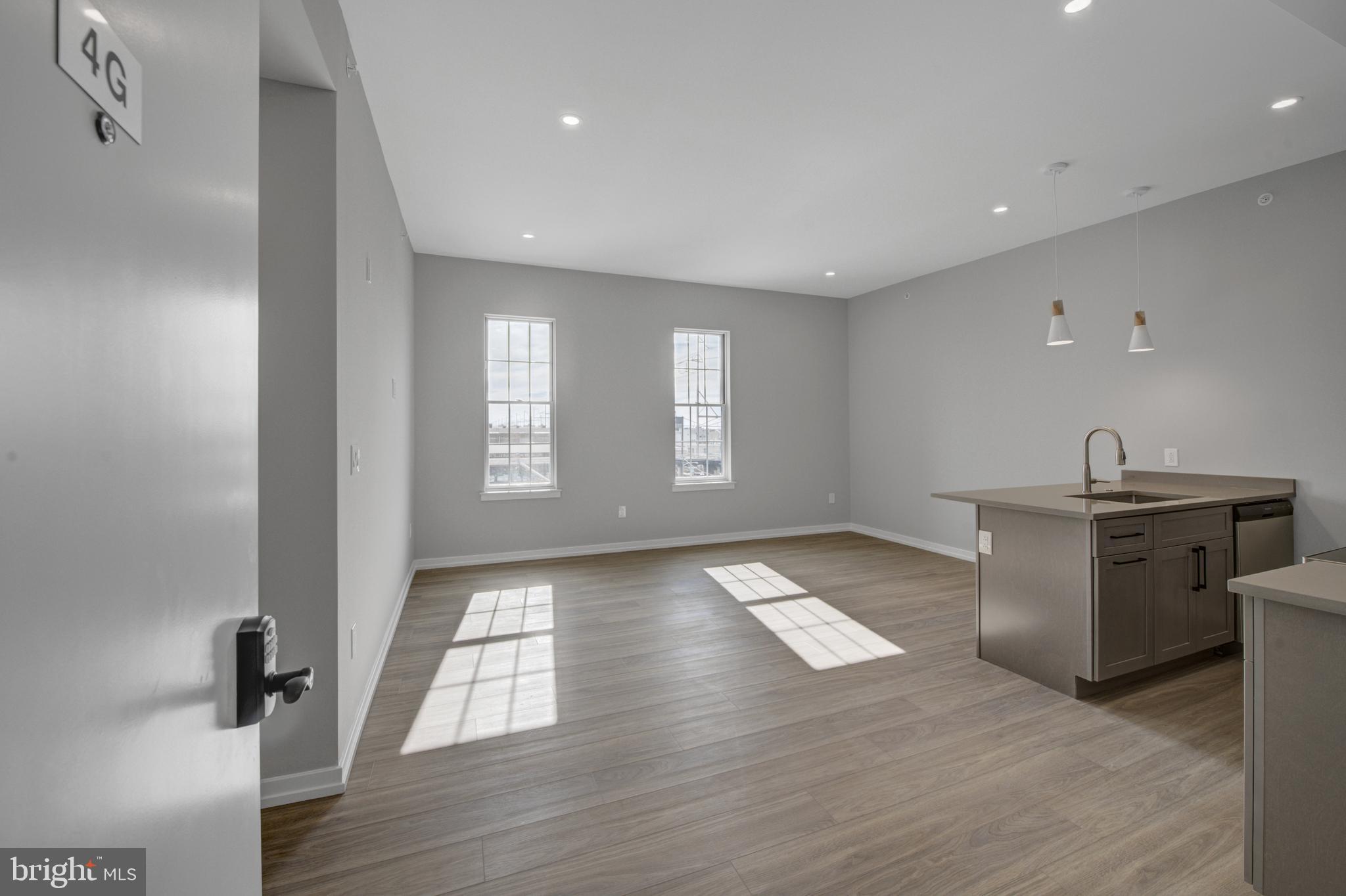 2445 Innovator Way, Unit 4G Philadelphia, PA 19146 - Photo 6 of 32 a view of an empty room with a window and wooden floor