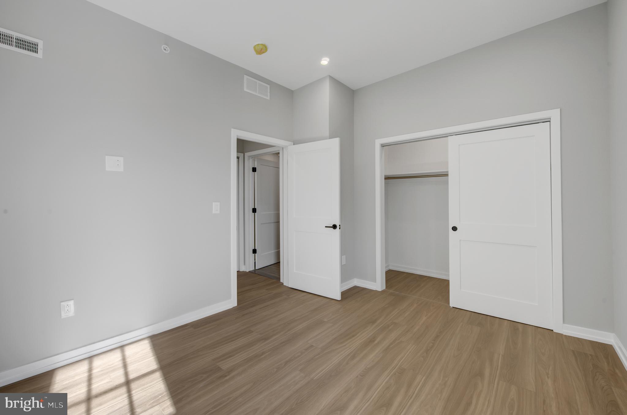 2445 Innovator Way, Unit 4G Philadelphia, PA 19146 - Photo 9 of 32 wooden floor in an empty room with a window