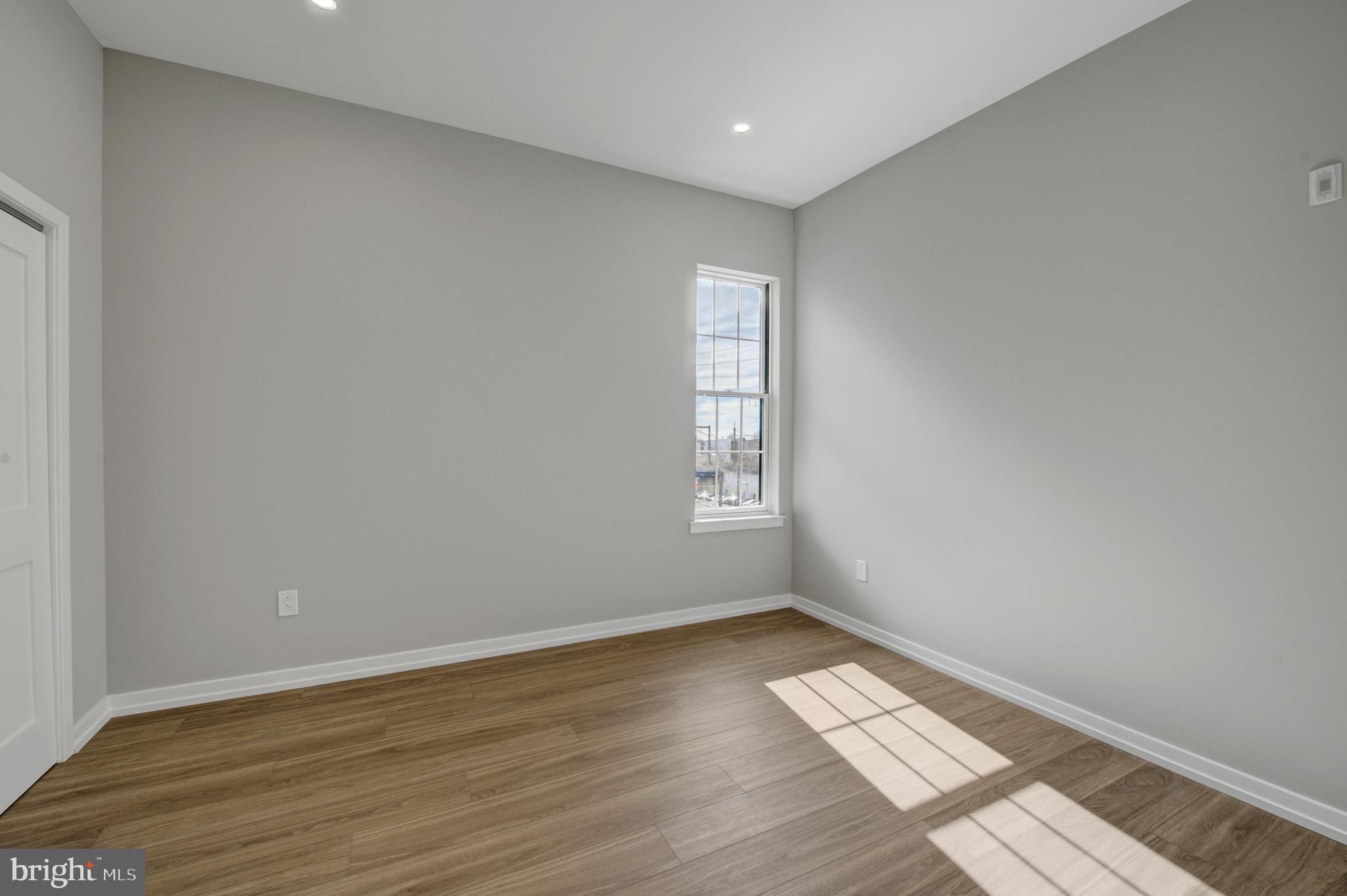 2445 Innovator Way, Unit 4G Philadelphia, PA 19146 - Photo 10 of 32 wooden floor in an empty room with a window
