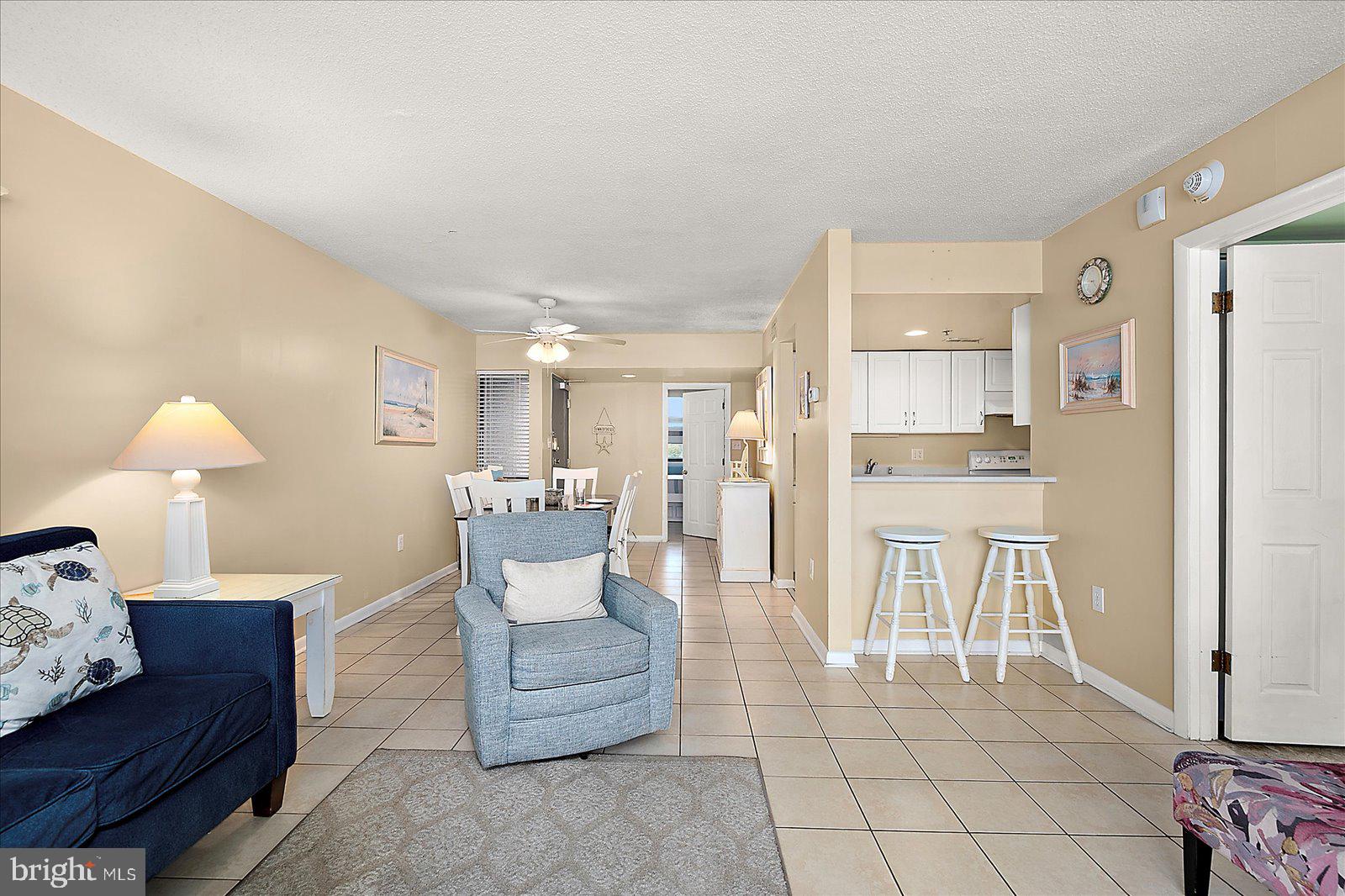 502 Island House Road Bethany Beach, DE 19930 - Photo 12 of 56 a living room with furniture and a dining table with kitchen view