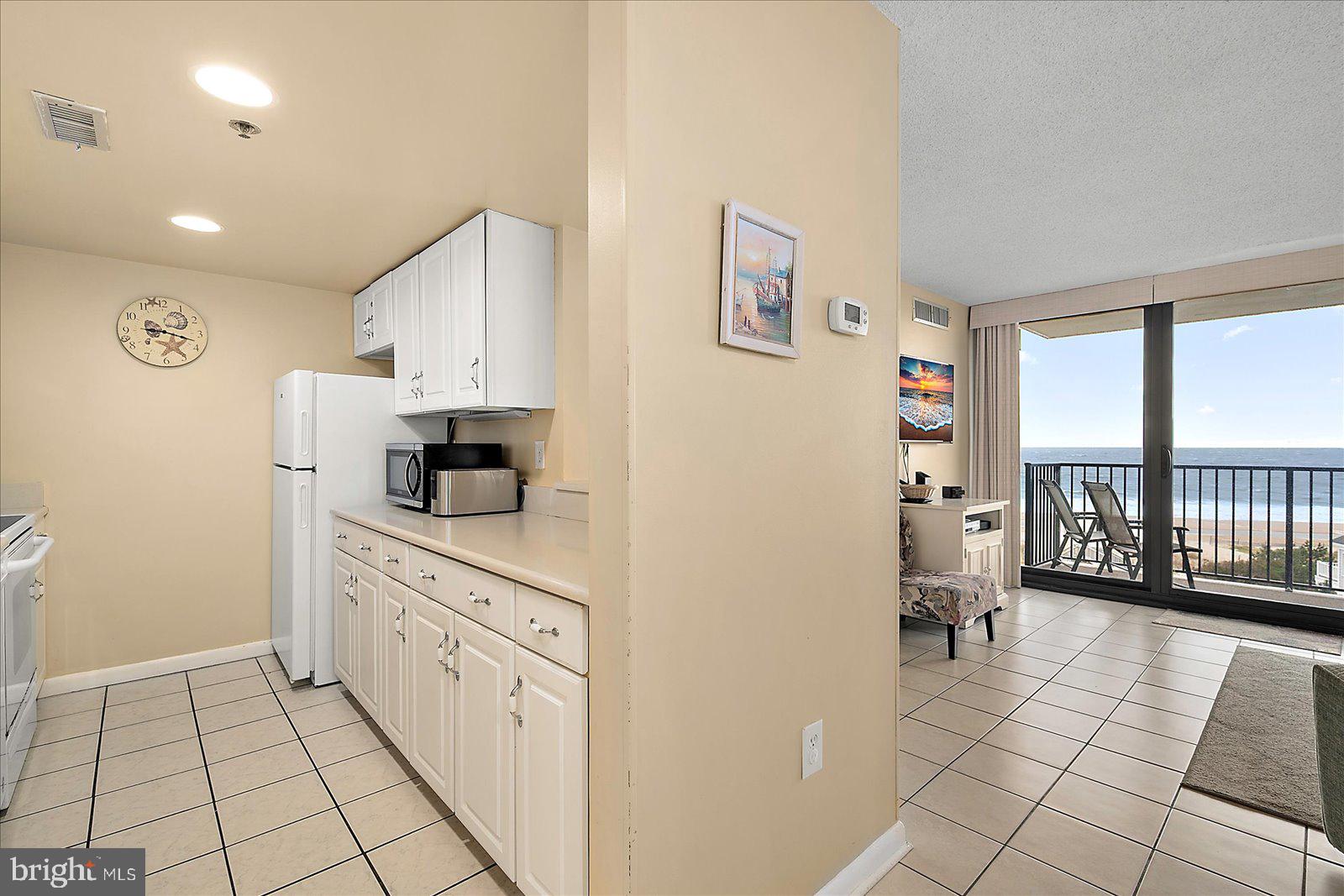 502 Island House Road Bethany Beach, DE 19930 - Photo 16 of 56 a kitchen with stainless steel appliances a refrigerator and a stove top oven