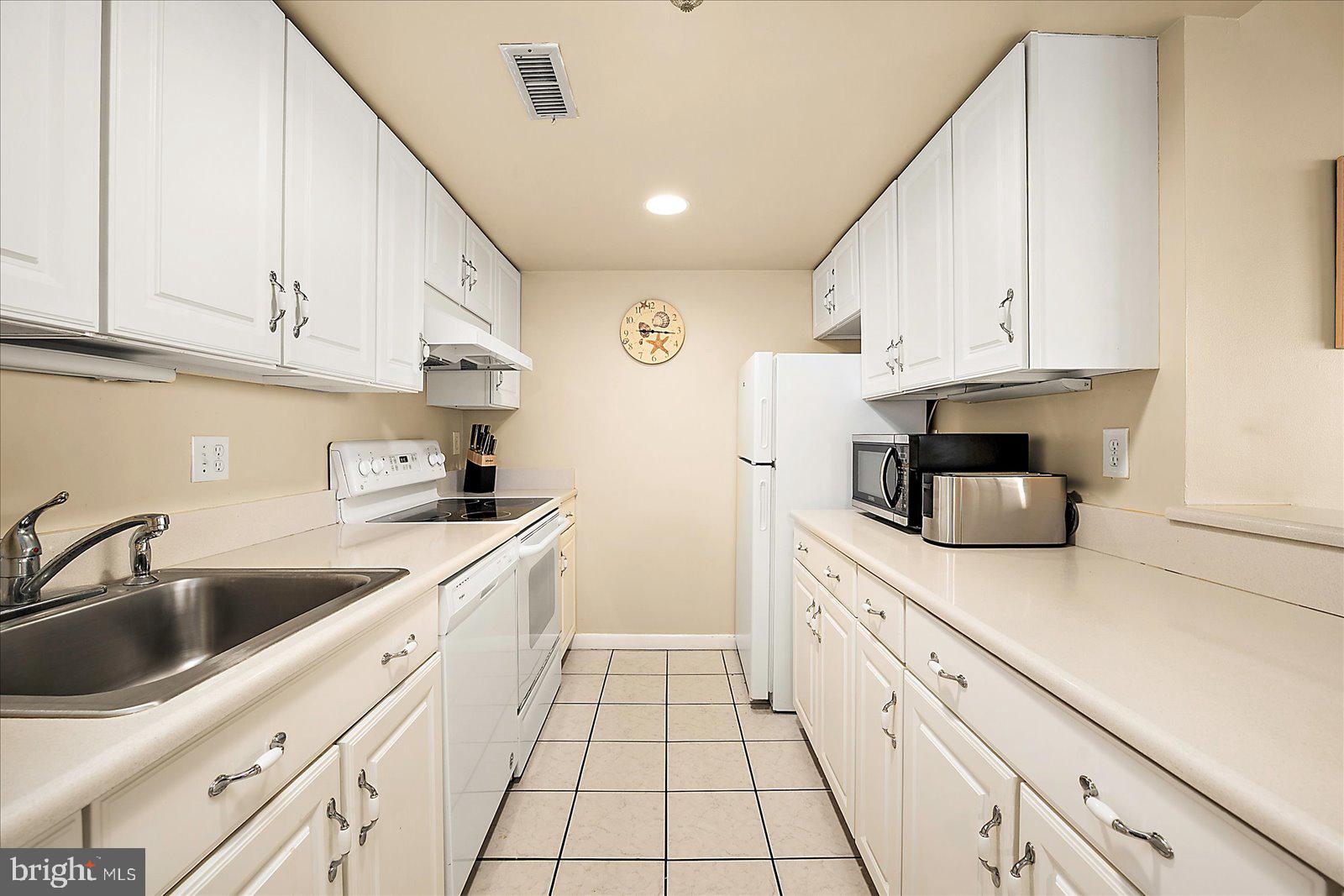 502 Island House Road Bethany Beach, DE 19930 - Photo 18 of 56 a kitchen with granite countertop a sink and cabinets