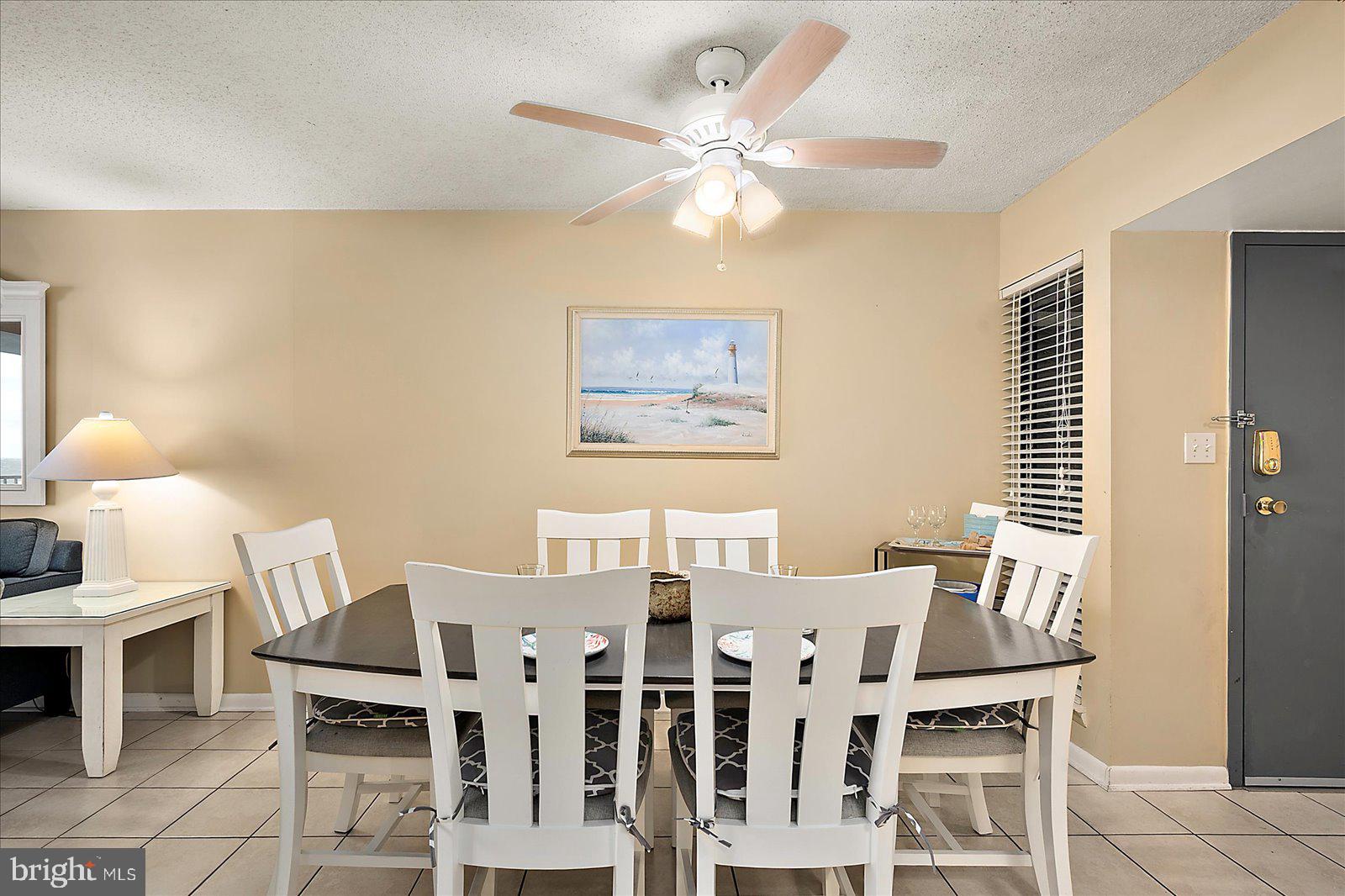 502 Island House Road Bethany Beach, DE 19930 - Photo 21 of 56 a view of a dining room with furniture and chandelier