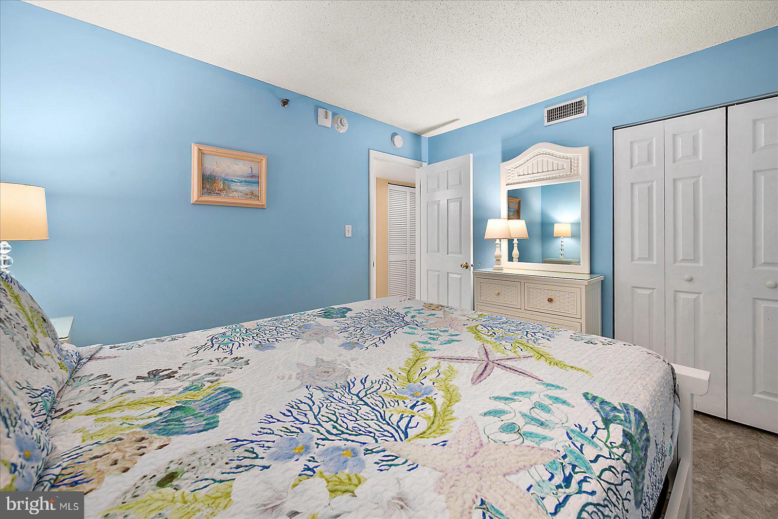 502 Island House Road Bethany Beach, DE 19930 - Photo 30 of 56 a bedroom with a bed and a dresser