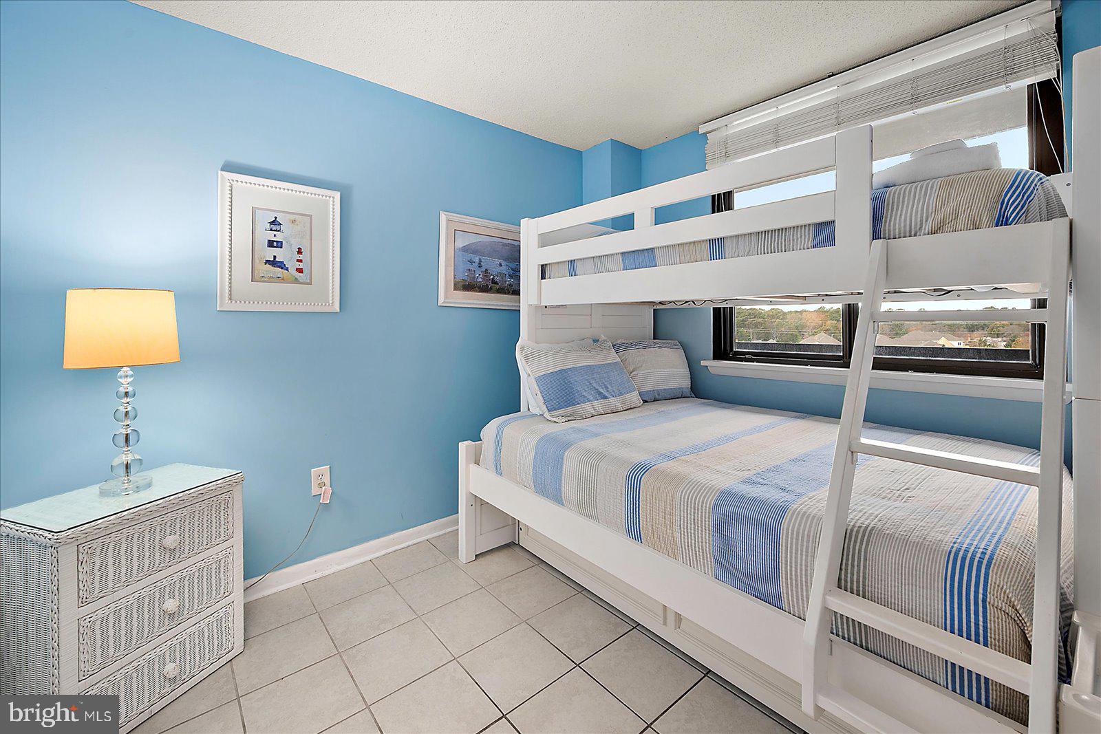 502 Island House Road Bethany Beach, DE 19930 - Photo 35 of 56 a bedroom with a bed and a table