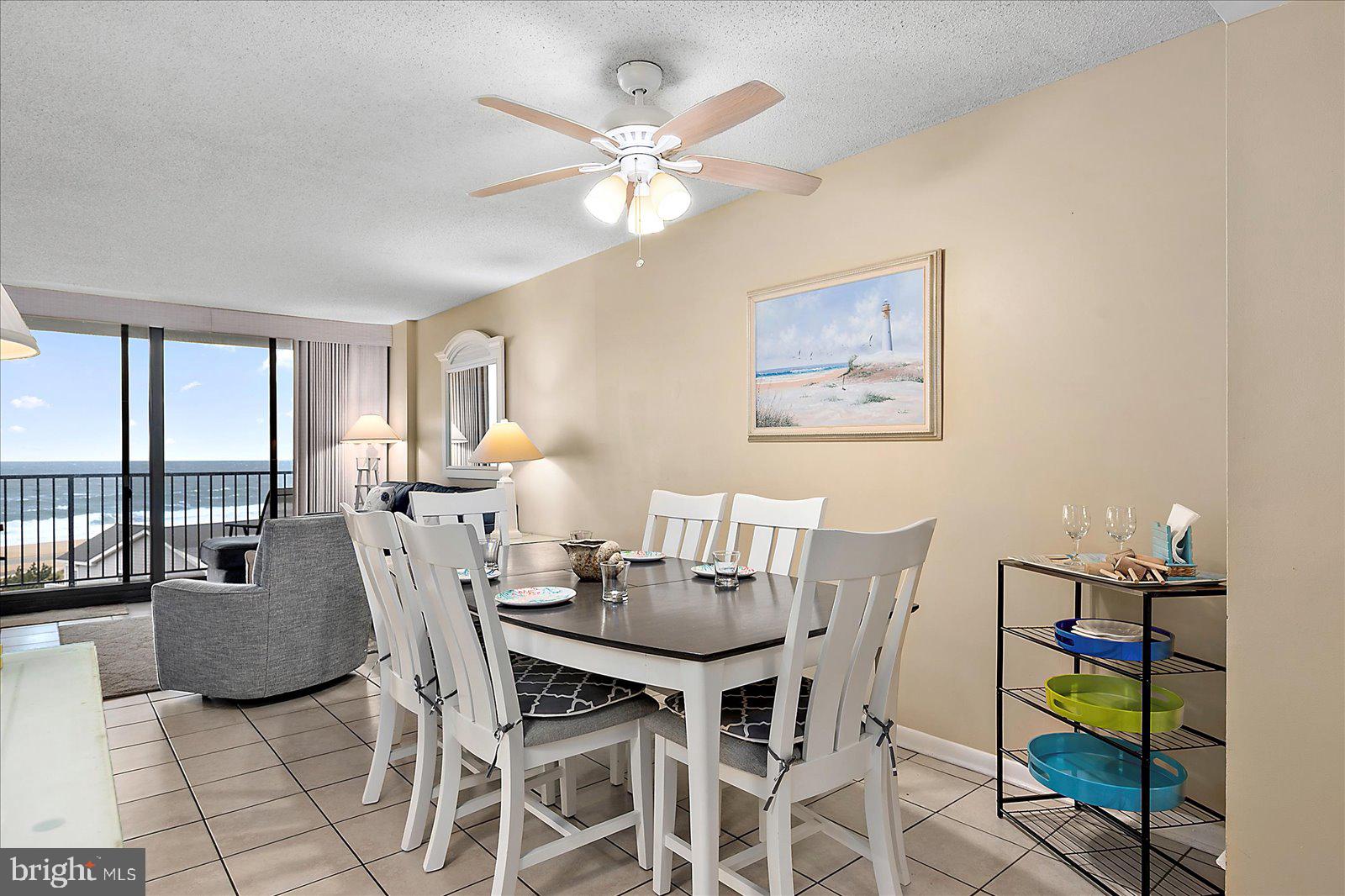 502 Island House Road Bethany Beach, DE 19930 - Photo 5 of 56 a view of a dining room with furniture and a chandelier
