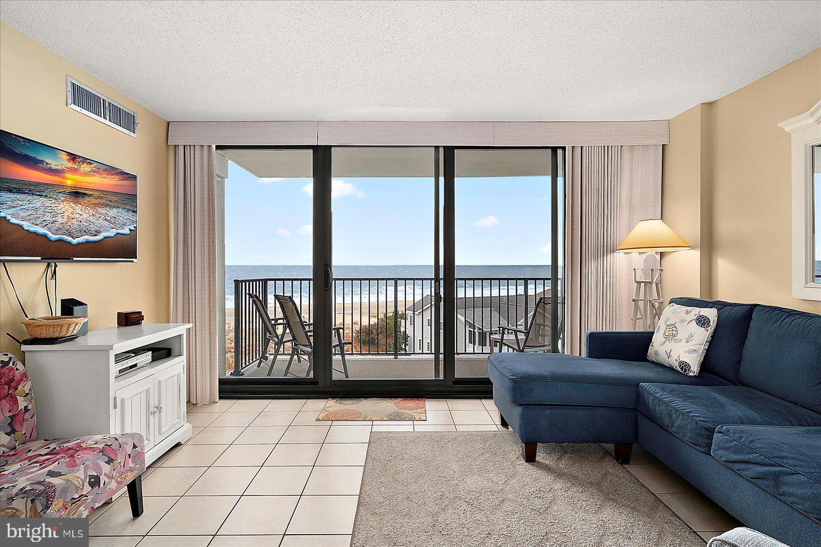 502 Island House Road Bethany Beach, DE 19930 - Photo 8 of 56 a living room with furniture and a flat screen tv