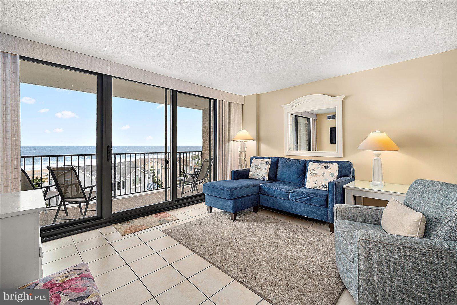502 Island House Road Bethany Beach, DE 19930 - Photo 9 of 56 a living room with furniture and a floor to ceiling window