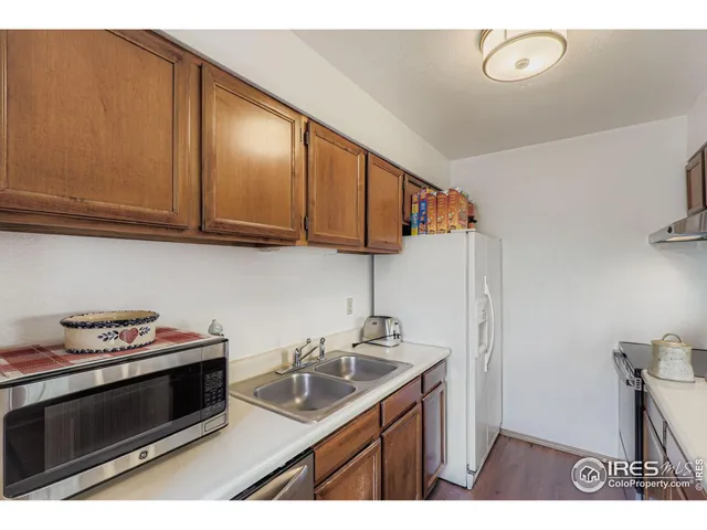 a kitchen with stainless steel appliances a stove a sink and cabinets