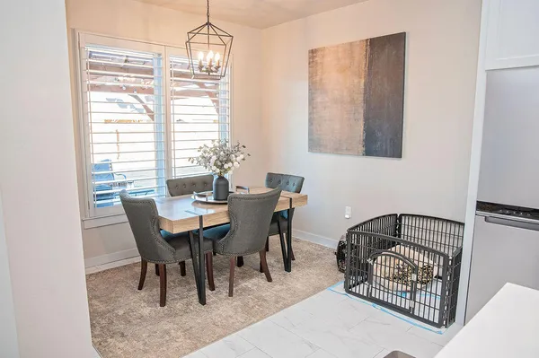 a dining room with furniture a chandelier and window