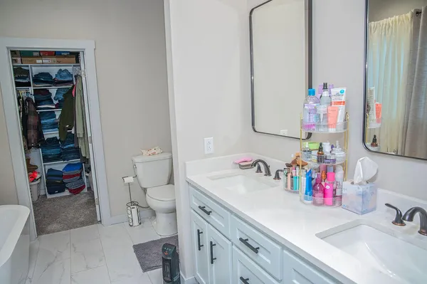 a bathroom with a sink vanity mirror and toilet
