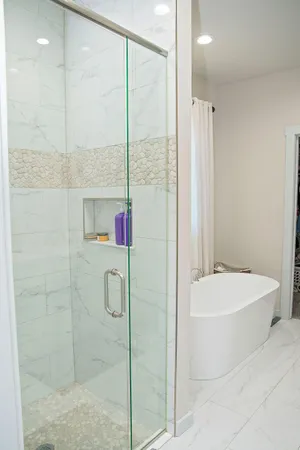 a bathroom with a bathtub and a shower