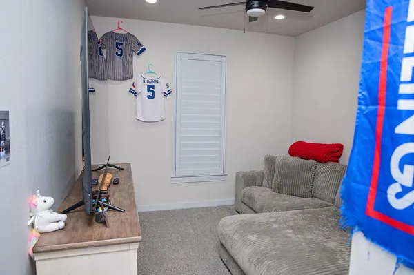 a living room with furniture and wall painting