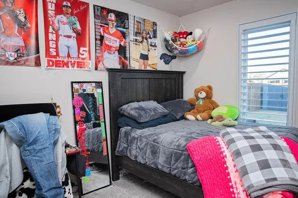 a bedroom with two beds and a painting on the wall