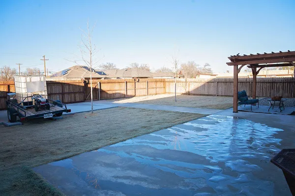 a backyard of a house with yard and outdoor seating