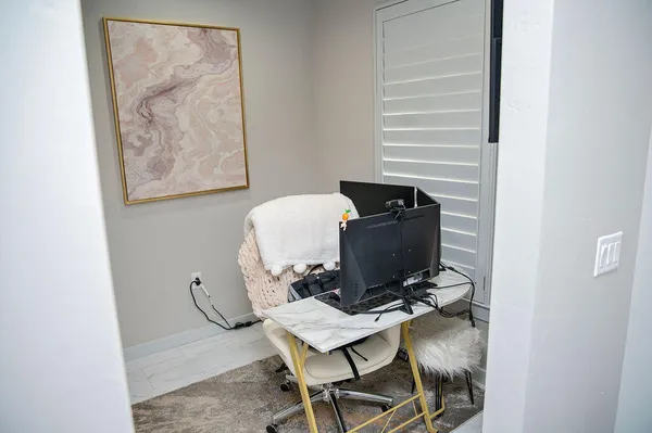 a workspace with furniture and a gate