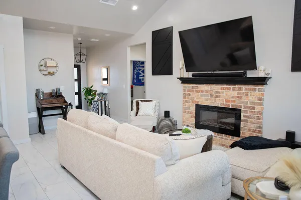 a living room with furniture and a fireplace