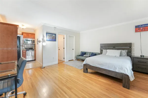 a bedroom with a bed and wooden floor