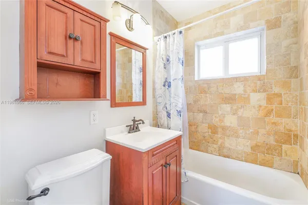 a bathroom with a sink a toilet and bathtub