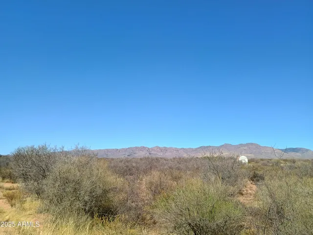 a view of a mountain range with lush green forest