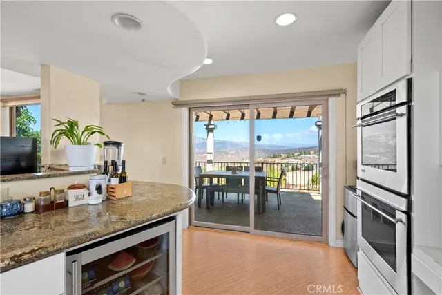 a kitchen with stainless steel appliances granite countertop a refrigerator stove and oven