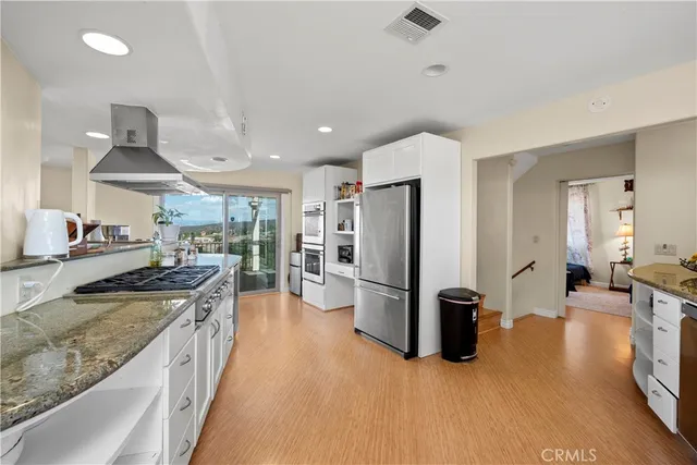 a kitchen with a stove and white cabinets