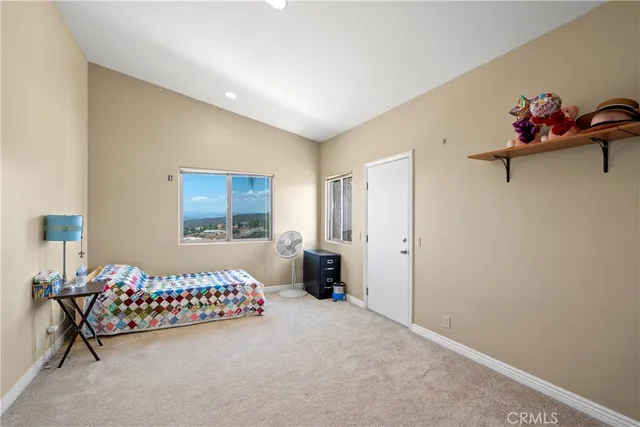 a living room with stainless steel appliances furniture a refrigerator and a table
