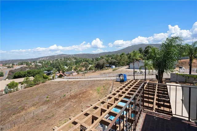 a view of a patio with table and chairs