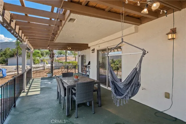 a view of a porch with chairs and backyard