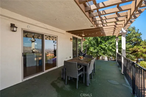 a view of a white house with iron fence