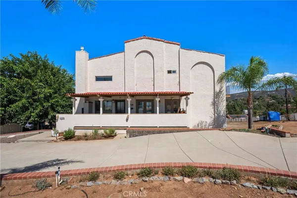 a view of a swimming pool with a patio and a yard