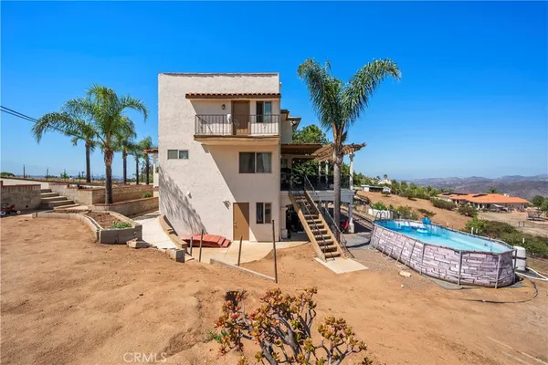 a view of a backyard with plants and a water fall