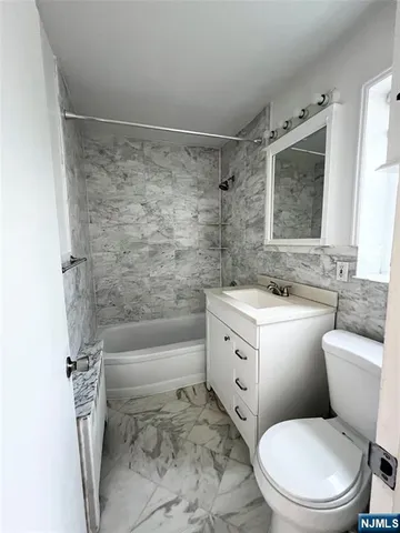 a bathroom with a toilet sink and bathtub