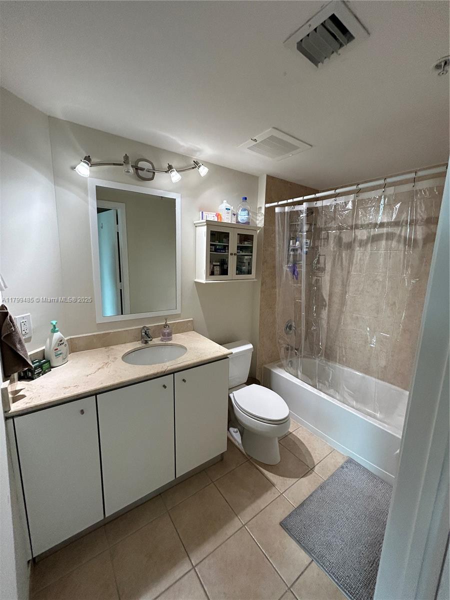 9066 Southwest 73rd Court, Unit 1504 Miami, FL 33156 - Photo 8 of 19 a bathroom with a double vanity sink toilet and shower