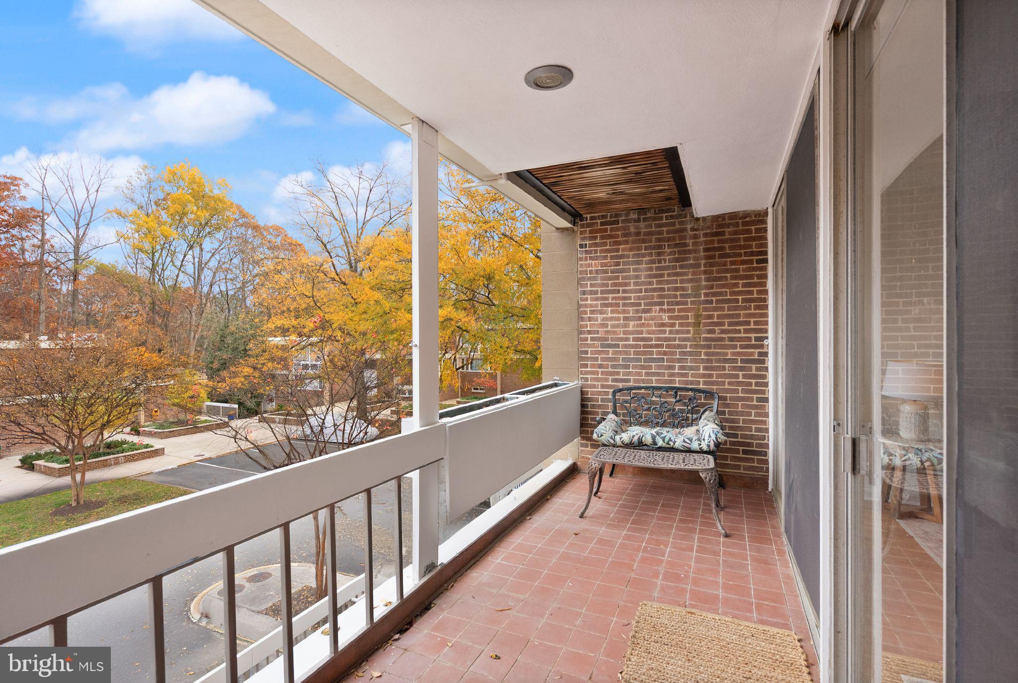 11577 Maple Ridge Road Reston, VA 20190 - Photo 20 of 48 a view of a balcony with furniture and floor to ceiling window