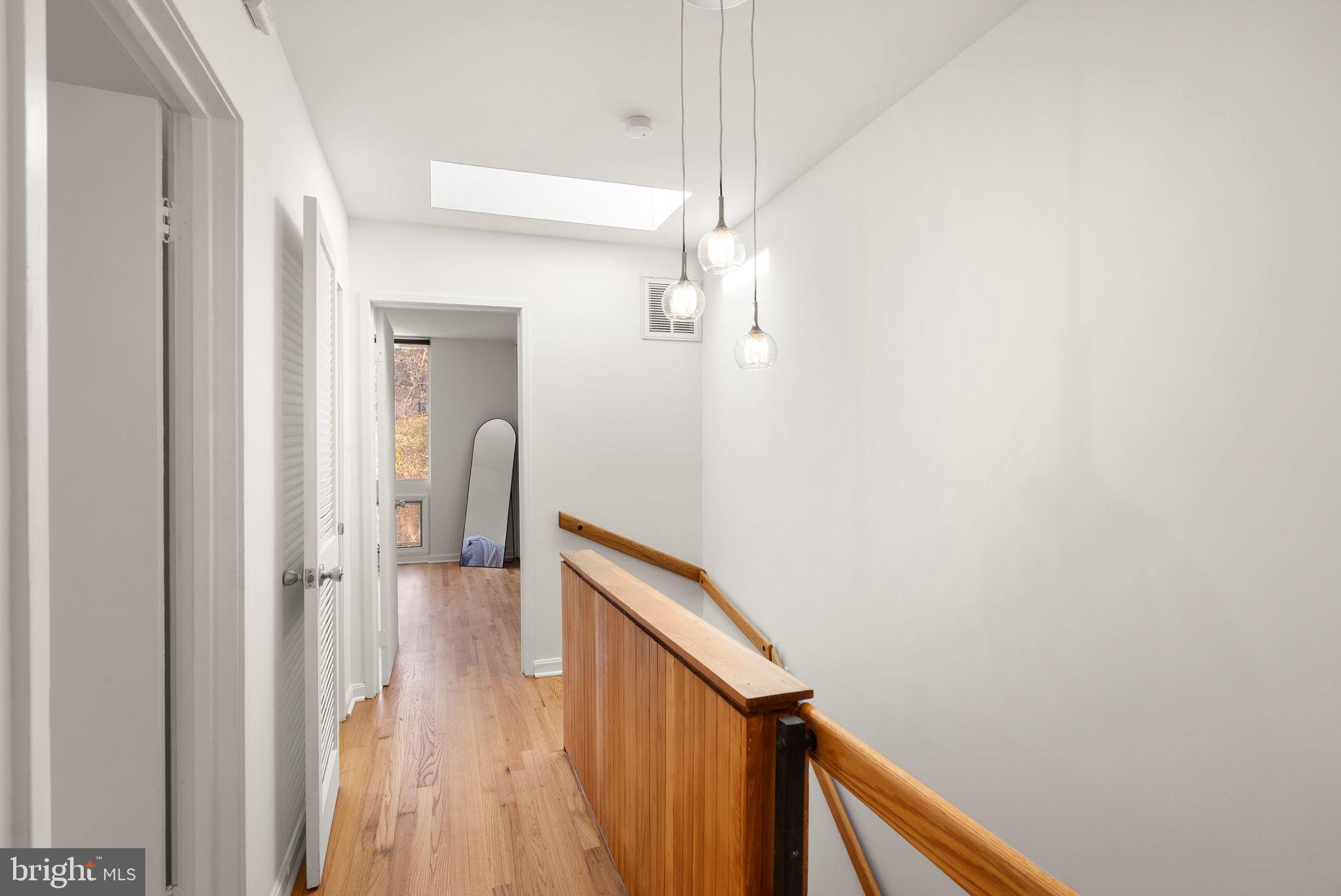 11577 Maple Ridge Road Reston, VA 20190 - Photo 30 of 48 a view of a hallway with wooden floor and staircase