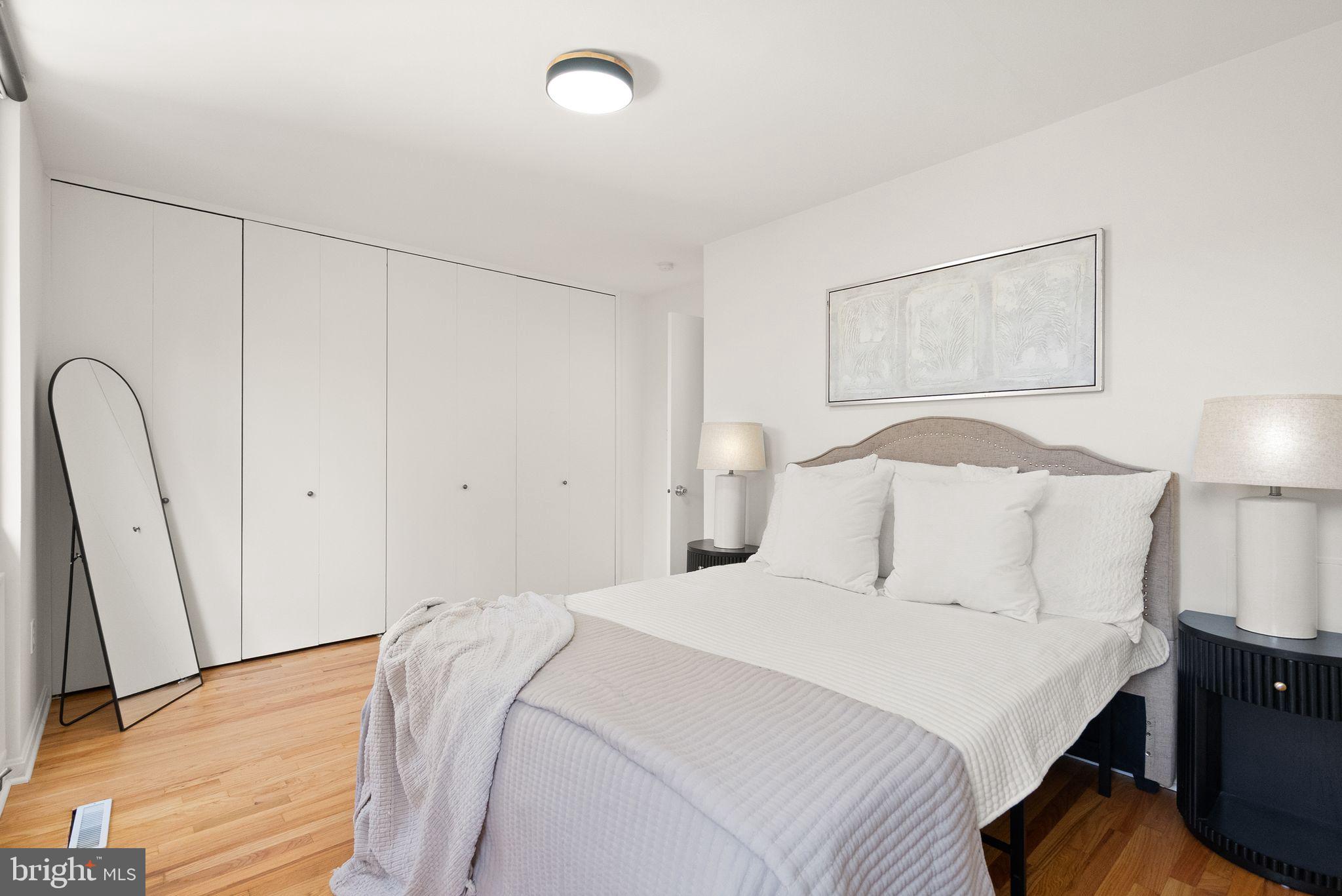 11577 Maple Ridge Road Reston, VA 20190 - Photo 33 of 48 a bedroom with a bed and a lamp on the dresser
